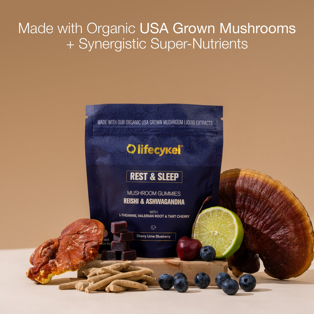 Lifecykel Rest & Sleep Mushroom Gummies packaging with mushrooms, fruits, and a lime on a beige background.