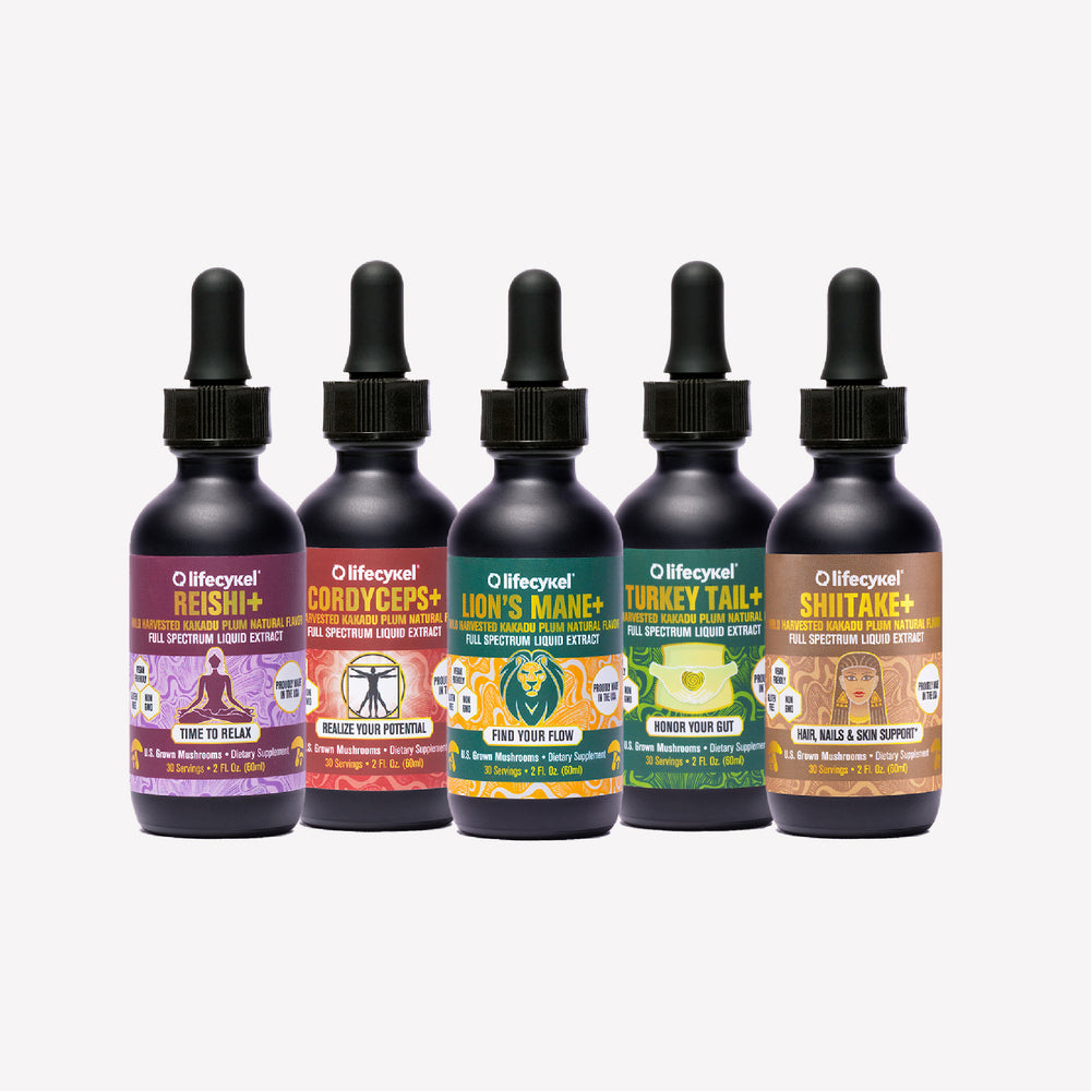 Set of five Lifecykel mushroom extracts  bottles with dropper caps on a white background