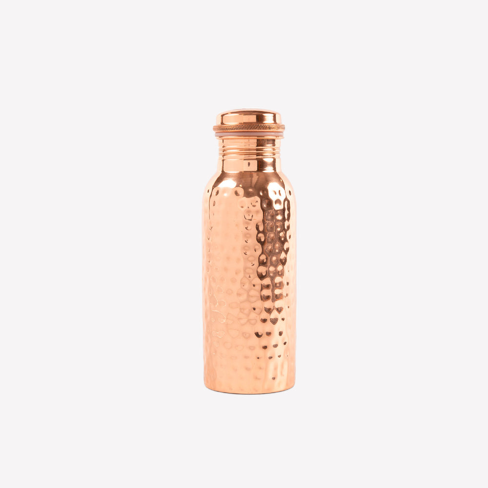 Copper water bottle with a textured surface on a white background