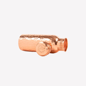 Copper water bottle with textured design on a white background