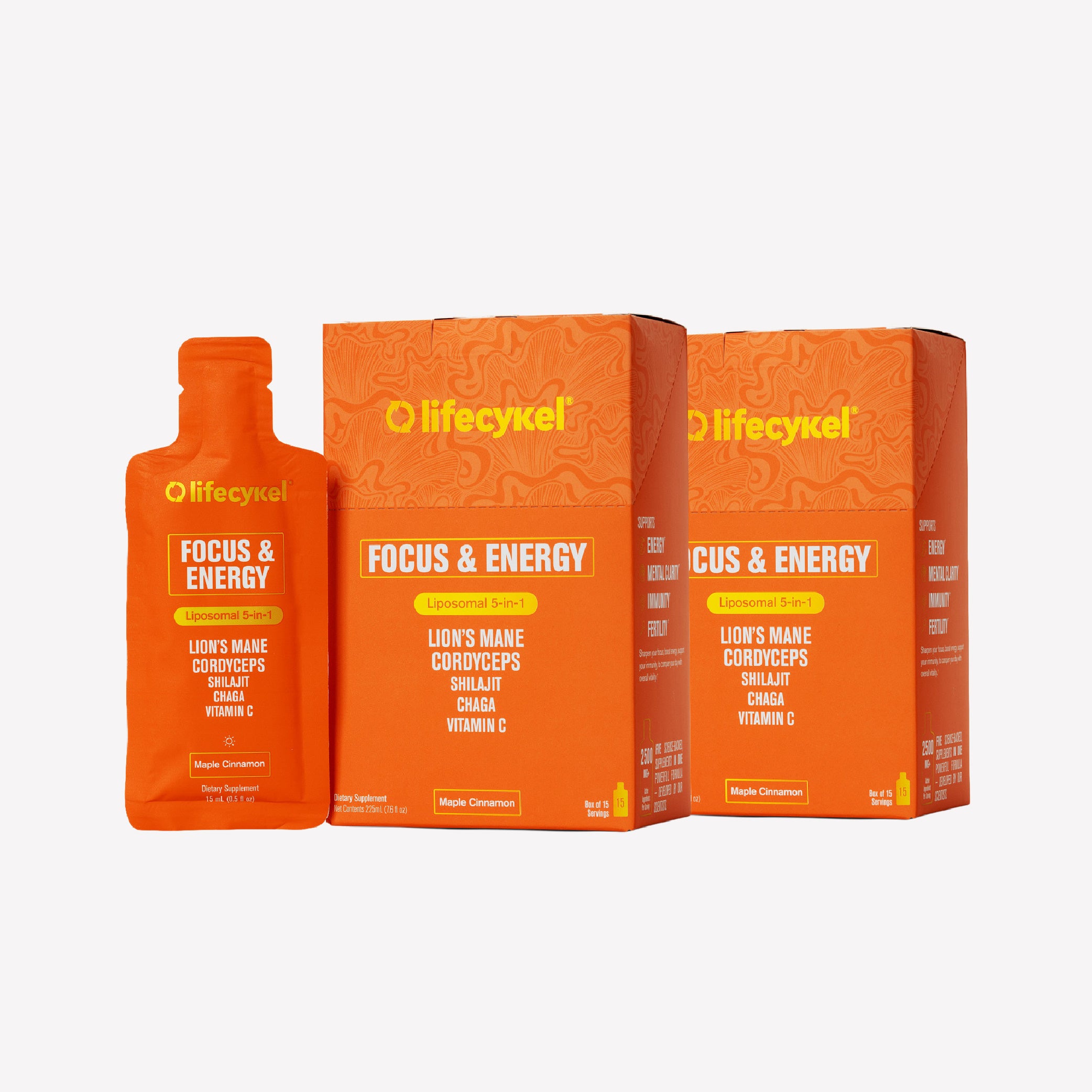 Three orange boxes and packets of Lifecykel Focus & Energy supplement on a white background