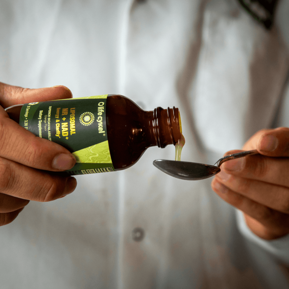 A bottle pouring the liquid syrup to a spoon