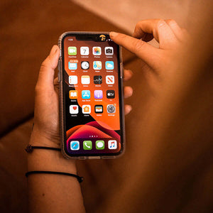 Hands holding the phone with Shroom cam cover